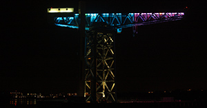 Titan Clydebank lit up in pink & blue